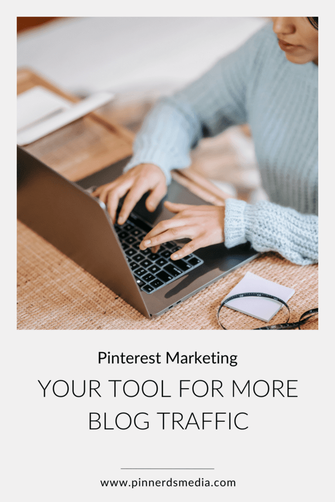 Woman in a blue sweater typing on a laptop, with a text overlay 'Your Tool for More Blog Traffic' for Pinterest Marketing.