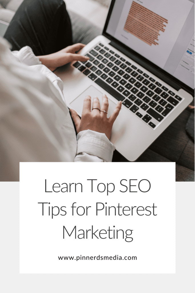 Close-up of hands typing on a laptop with a document displayed, promoting learning SEO tips for Pinterest marketing.