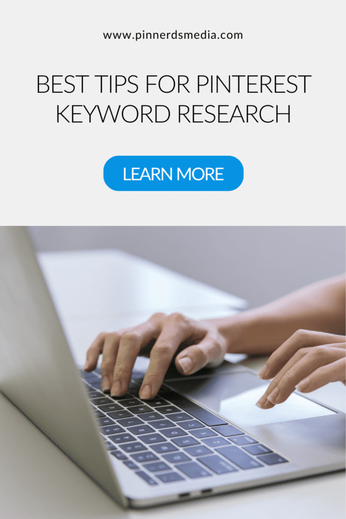 Close-up of hands on a laptop with a call to action for learning Pinterest keyword research tips.