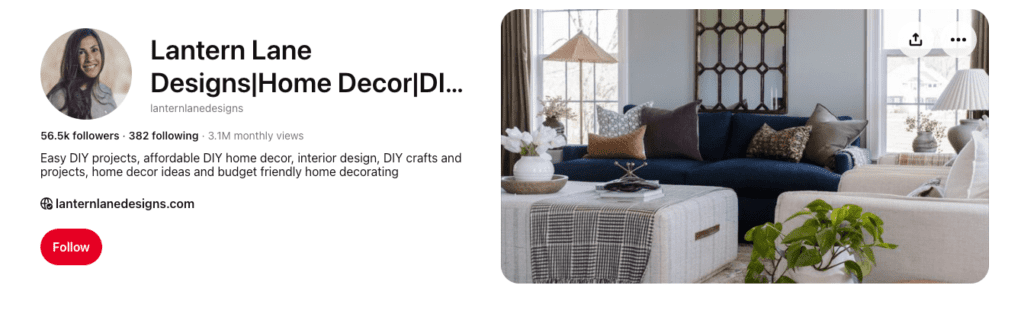 Cozy living room with navy sofa, patterned pillows, and stylish decor from Lantern Lane Designs Pinterest profile.