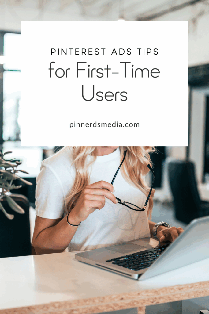 Woman holding glasses while working on a laptop with a text overlay that says “Pinterest Ads Tips for First-Time Users” and the URL pinnerdsmedia.com.